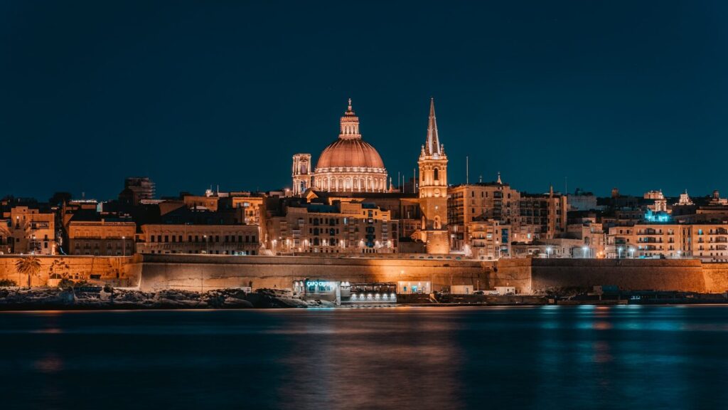 a night view of a large city with a cathedral